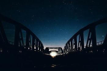 silhouette of gray metal bridge
