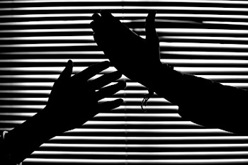Silhouette of Hands With Venetian Blinds Background