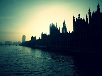 Silhouette of High Rise Buildings Beside Body of Water during Golden Hour