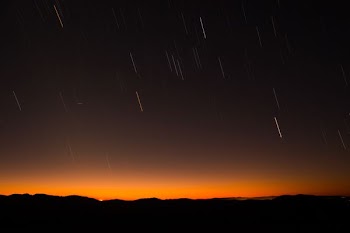 silhouette of hill during night time