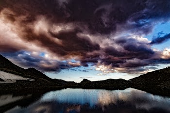 Silhouette of Island Under Dark Cloudy Sky