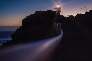 silhouette of lighthouse during daytime