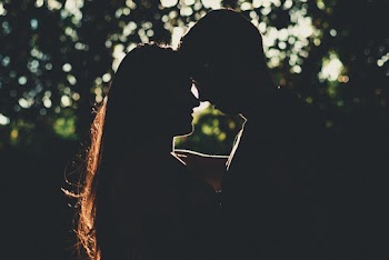 Silhouette of Man and Woman Near Tree