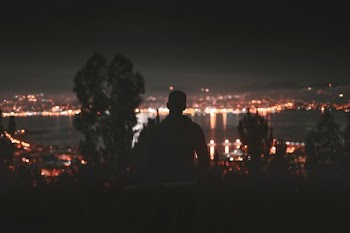 silhouette of man facing in front of building