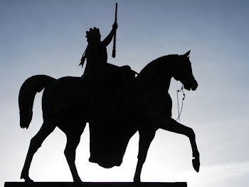 Silhouette of Man Holding Rifle Riding on Horse