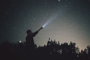 silhouette of man looking up during nighttime