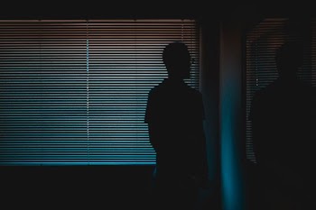 silhouette of man near window