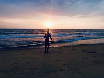 Silhouette of Man Playing Ball in Seashore