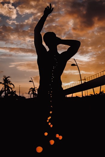 Silhouette Of Man Raising Hand