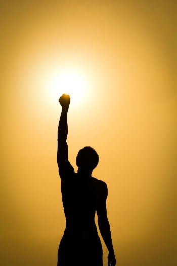 Silhouette of Man Raising Hand at Golden Hour