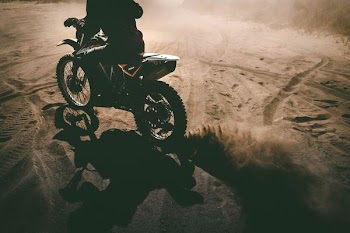 silhouette of man riding dirt bike