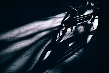 silhouette of man sitting on bench