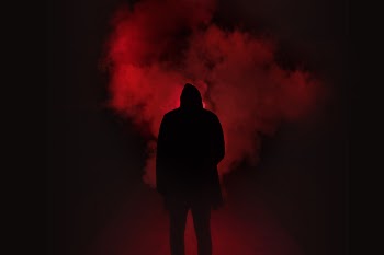 Silhouette of Man Standing Against Black And Red Background