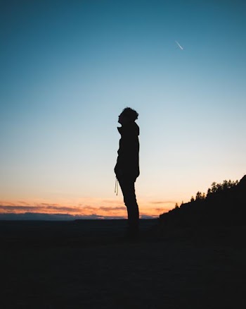 silhouette of man standing on field