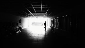 Silhouette of Man Walking on Hall