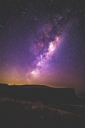 silhouette of mountain during milky way at nighttime