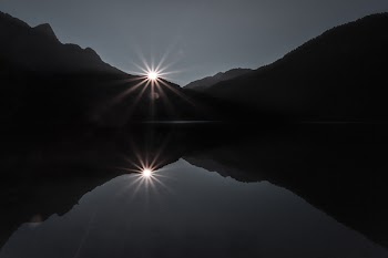 Silhouette Of Mountain Near Body Of Water