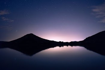 silhouette of mountain near body of water