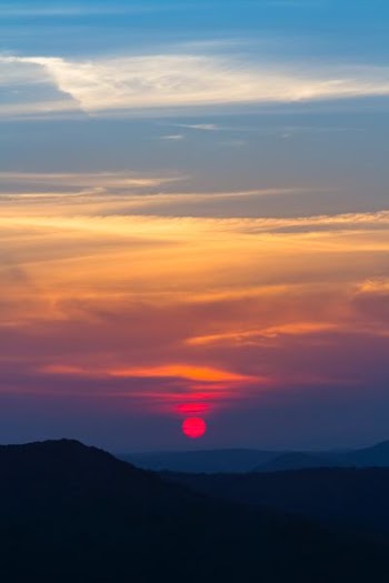 silhouette of mountain under blue sky