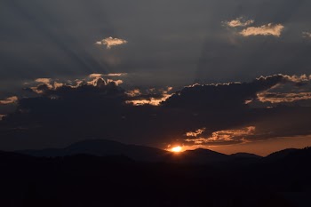 Silhouette of Mountain Under Cloudy Sky