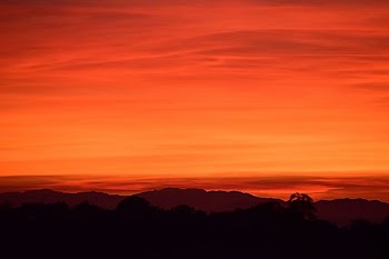 silhouette of mountain under orange sky