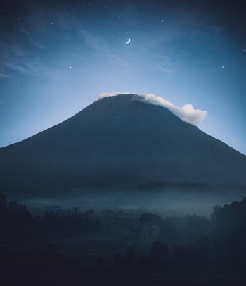 Silhouette of Mountain With Mist on Top