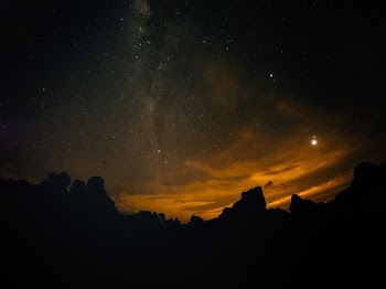 silhouette of mountains at nighttime