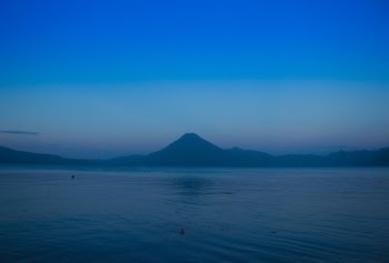 silhouette of mountains between sea and sky