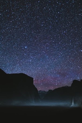 silhouette of mountains during starry night