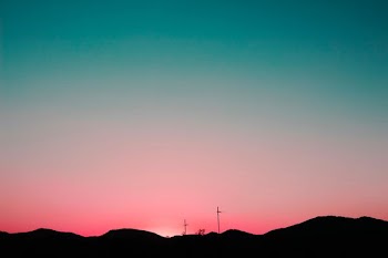 silhouette of mountains under pink and blue sky