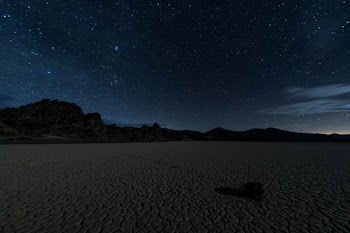 silhouette of mountains under starry night