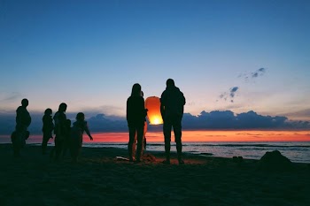 Silhouette of People by the Sea