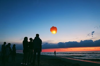 Silhouette of people by the sea.