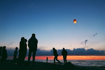 Silhouette of people by the sea.