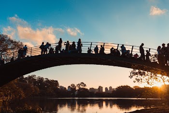Silhouette Of People On Bridge Under Blue Sky 