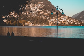 Silhouette of People Sitting on Riverbank