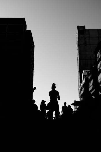 Silhouette of People Standing  Near Buildings