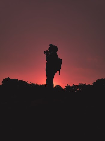 Silhouette Of Person Carrying Backpack