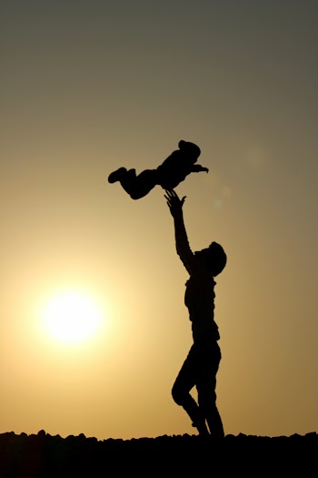 Silhouette of Person Catching A Baby