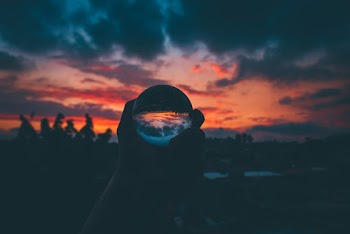 Silhouette of Person Holding Clear Ball