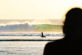 Silhouette Of Person Holding Surfboard