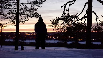 silhouette of person in between two trees