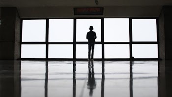 silhouette of person near window