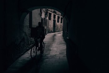 silhouette of person riding bicycle in tunnel