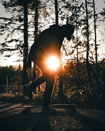 Silhouette of Person Riding Skateboard during Sunset