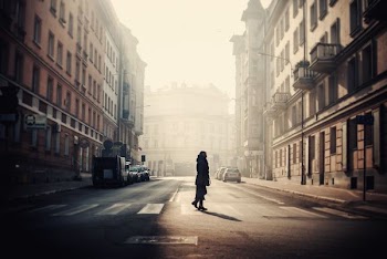 silhouette of person standing between two buildings