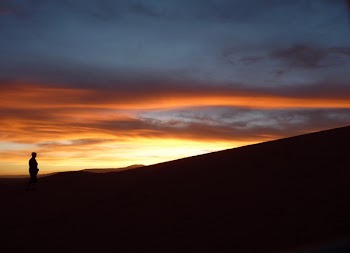 Silhouette of Person Standing Facing the Sunset