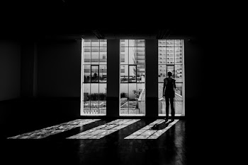 Silhouette Of Person Standing Facing Window