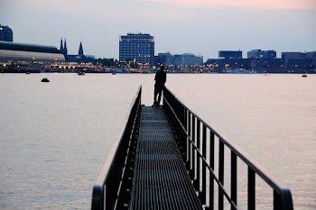 silhouette of person standing on metal dock