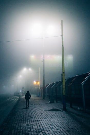 Silhouette of Person Walking on Street